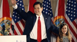 U.S. Republican Senate candidate Marco Rubio waves beside his daughter during his victory speech at a rally in Florida