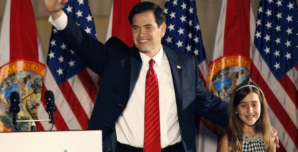U.S. Republican Senate candidate Marco Rubio waves beside his daughter during his victory speech at a rally in Florida
