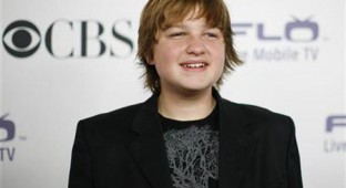Angus T. Jones poses at the CBS comedies' season premiere party in Los Angeles