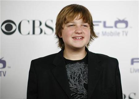 Angus T. Jones poses at the CBS comedies' season premiere party in Los Angeles