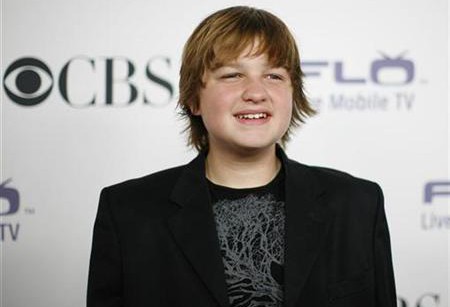 Angus T. Jones poses at the CBS comedies' season premiere party in Los Angeles