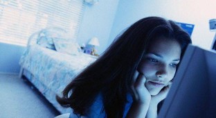 Teenager Using Computer in Bedroom --- Image by   L. Clarke/CORBIS