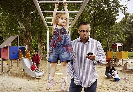 DAD ON CELL W CHILD