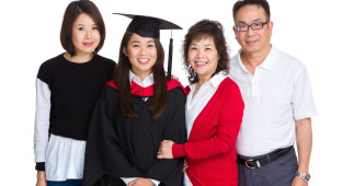 Happy family gathered together with graduate student