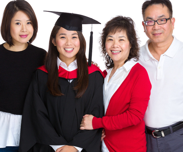 Happy family gathered together with graduate student