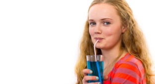 Blonde teenage girl drinking soda