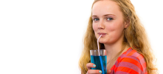 Blonde teenage girl drinking soda