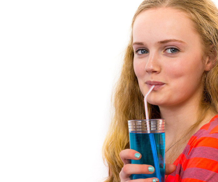 Blonde teenage girl drinking soda