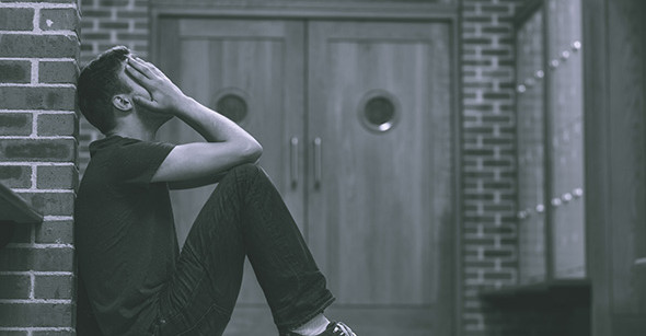 Stressed out student in hallway of school building.