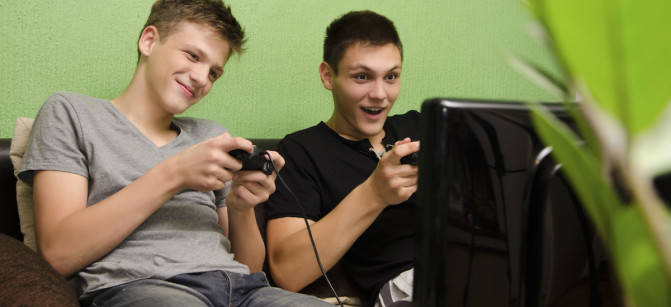 Kids playing video game in their room