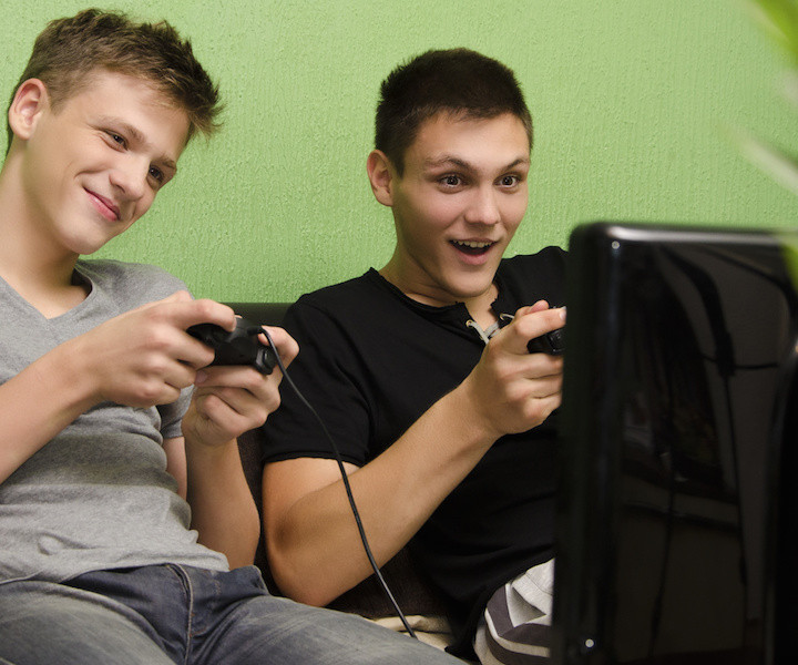 Kids playing video game in their room