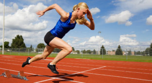 Track athlete exploding out of the starting blocks