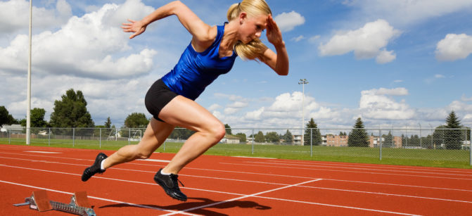 Track athlete exploding out of the starting blocks