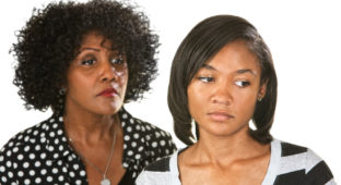 Sad mother with teenage daughter on isolated background