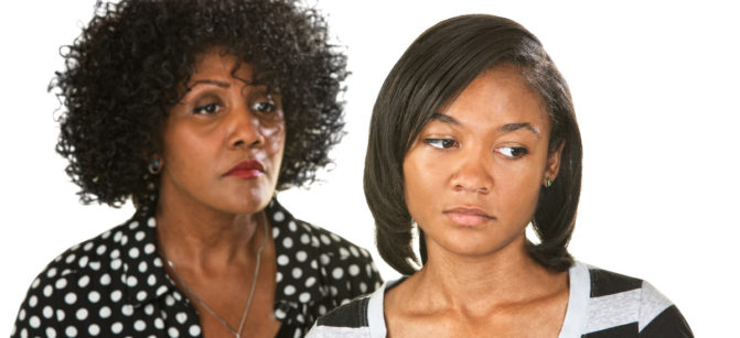 Sad mother with teenage daughter on isolated background