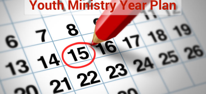 Setting an important date on a calendar with a red pencil marking a day of the month representing organizing time and schedule.