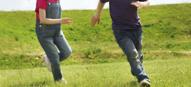 happy-boy-girl-running-outdoors