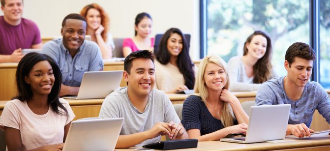 Students Using Laptops And Digital Tablets In Lecture