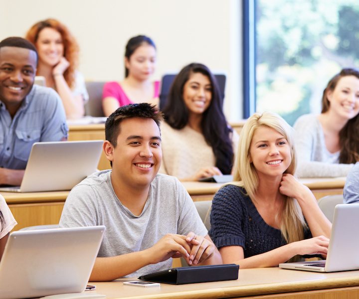 Students Using Laptops And Digital Tablets In Lecture