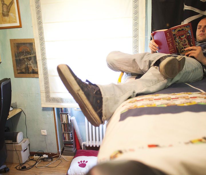 Pablo Vega, a former video-game tester for Electronic Arts Inc. who is forced to live at home because of his job situation, reads a book in his bedroom in Madrid, Spain, on Monday, May 28, 2012. More than half of all workers under age 24 are jobless and 37 percent of Spaniards between 18 and 34 live with their parents. Photographer: Angel Navarrete/Bloomberg *** Local Caption *** Pablo Vega Gonzalez