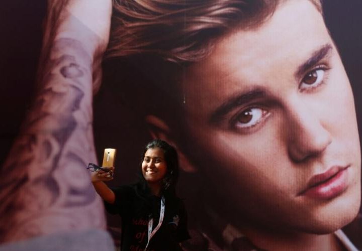 A girl takes a selfie in front of a hoarding outside the venue of Canadian singer Justin Bieber concert in Mumbai, India May 10, 2017. REUTERS/Shailesh Andrade