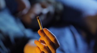 Smoking joint. Hand close up