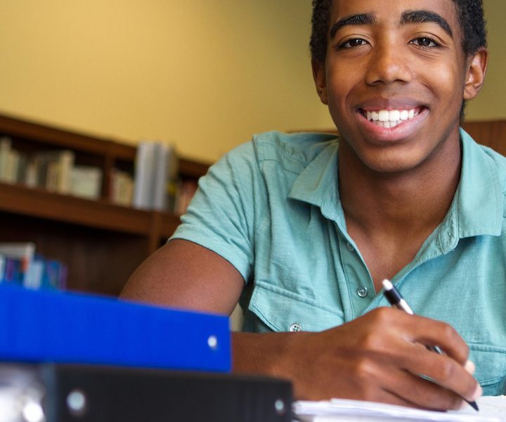 Black teenager studying school smile