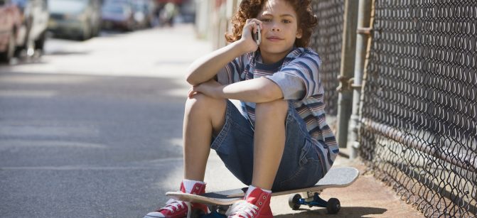 Mixed Race boy talking on cell phone