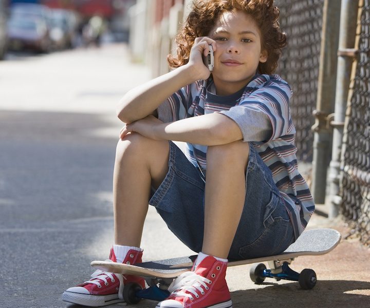 Mixed Race boy talking on cell phone