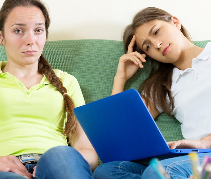 Two sad student Girl computer bullied