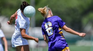 Soccer player using head to hit the ball