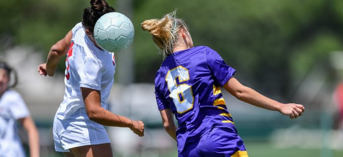 Soccer player using head to hit the ball