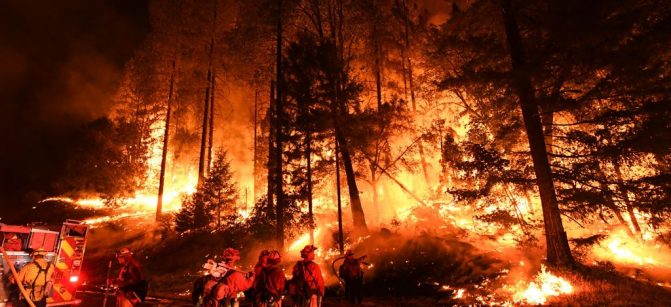 TOPSHOT - Firefighters try to control a back burn as the Carr fire continues to spread towards the towns of Douglas City and Lewiston near Redding, California on July 31, 2018. - Two firefighters were killed fighting the blaze and three people, a 70 year old woman and her two great-grandchildren age four and five, perished when their Redding home was rapidly swallowed up by flames. (Photo by Mark RALSTON / AFP)        (Photo credit should read MARK RALSTON/AFP/Getty Images)