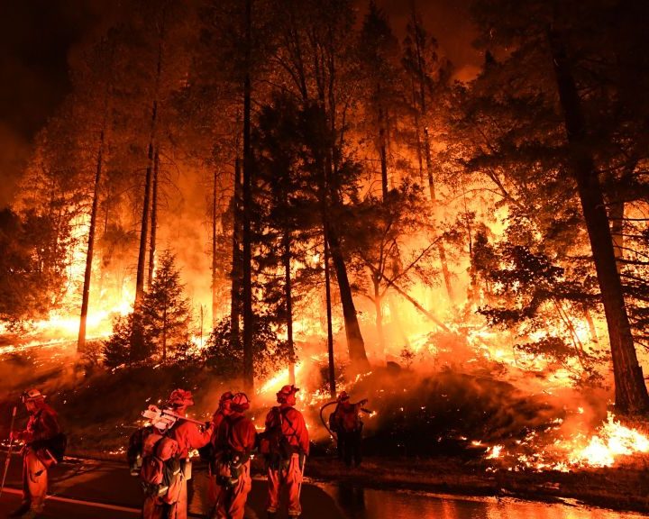 TOPSHOT - Firefighters try to control a back burn as the Carr fire continues to spread towards the towns of Douglas City and Lewiston near Redding, California on July 31, 2018. - Two firefighters were killed fighting the blaze and three people, a 70 year old woman and her two great-grandchildren age four and five, perished when their Redding home was rapidly swallowed up by flames. (Photo by Mark RALSTON / AFP)        (Photo credit should read MARK RALSTON/AFP/Getty Images)