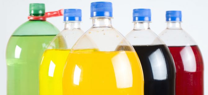 Carbonated drinks in plastic bottles. Multicolored drinks. Studio shot