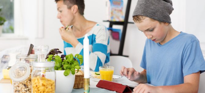 Mother and son having breakfast together in the morning