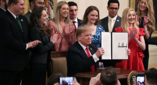 WASHINGTON, DC - MARCH 21: U.S. President Donald Trump holds up an executive order he signed protecting freedom of speech on college campuses during a ceremony in the East Room at the White House March 21, 2019 in Washington, DC. Surrounded by student who have said their conservative views are suppressed at universities across the country, Trump signed the order ‘improving free inquiry, transparency, and accountability on campus,’ according to the White House. (Photo by Chip Somodevilla/Getty Images)