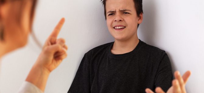 Woman having a fight with her teenager son - gesturing and expressing disagreement with each other