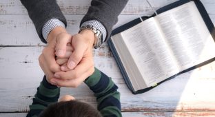 Dad family father and his little son's hands praying together after bible study in the morning. Christianity, Parenting and Raising child in God's way, Thankful moment, Happy father's day.