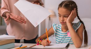 Bad note. Cheerless bored girl listening to her mother while receiving a bad note from her