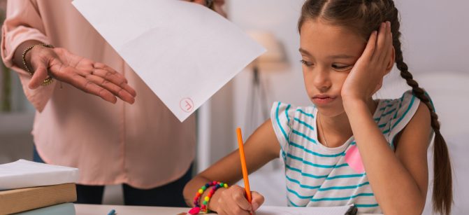 Bad note. Cheerless bored girl listening to her mother while receiving a bad note from her